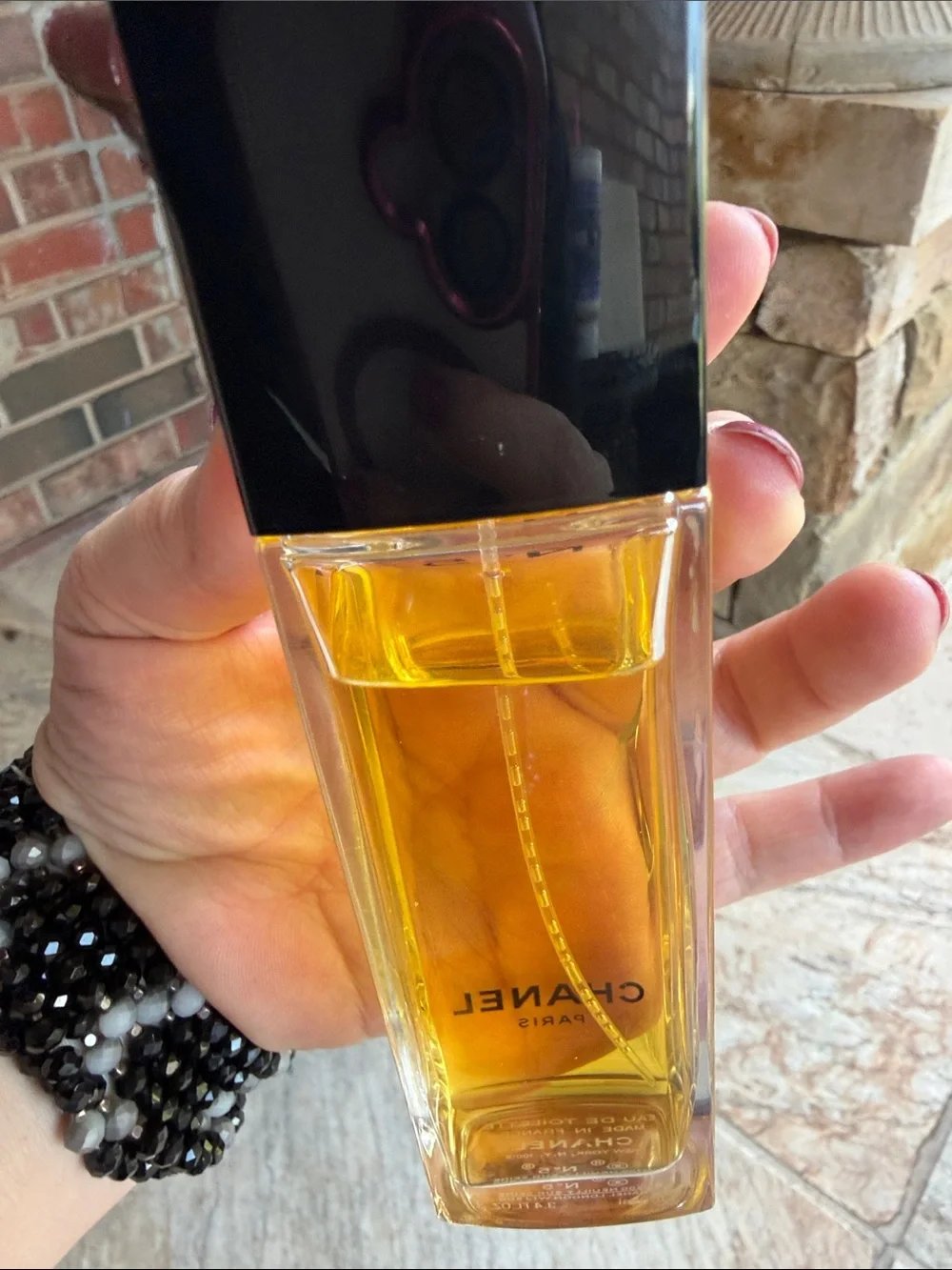 CHANEL  — Clear Bottle with Black Cap and Golden Liquid